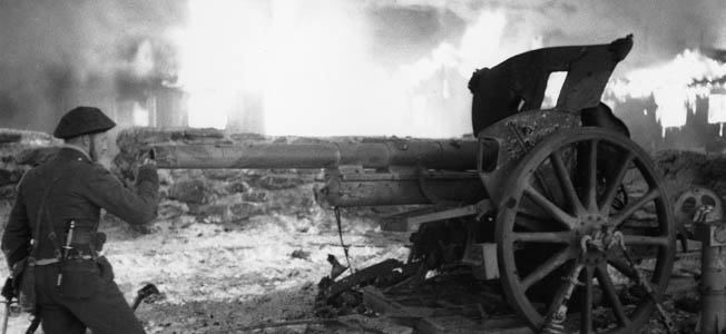 Jack Churchill inspecting the wreckage of a German field gun following action against elements of the Wehrmacht in France. 