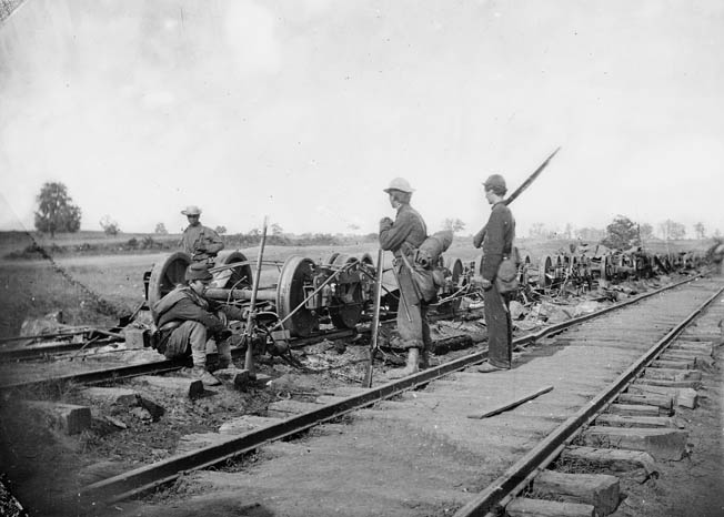 Union soldiers survey the damaged rolling stock of the Orange & Alexandria Railroad at Manassas Junction shortly before the Battle of Brawner’s Farm. The junction was fought over frequently during the war.