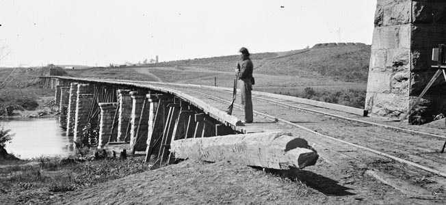 This bridge at Strawberry Plains was the northernmost target of pro-Union arsonists on “the Night of the Burning Bridges.” It is shown in an 1864 photograph under Union guard.