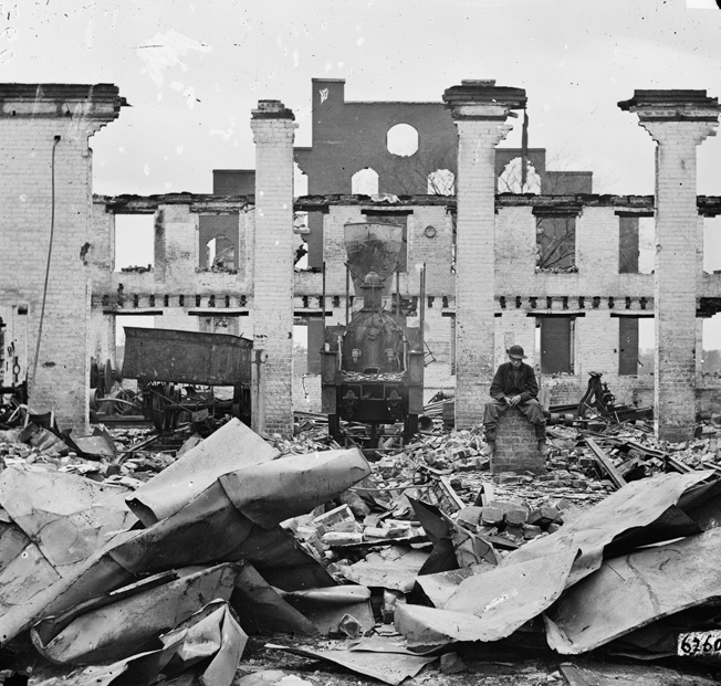 Ruins of the Richmond & Petersburg Railroad depot, with the remains of a smashed locomotive in the foreground. 