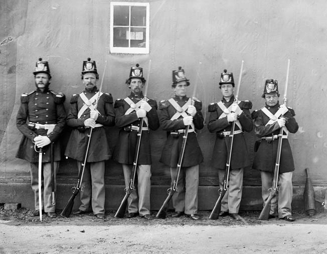 A Marine officer in full dress, far left, proudly shows off his troops in this 1862 photo by famed photographer Mathew Brady.