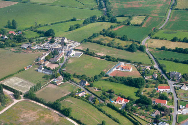 A recent aerial view of Graignes, taken from the southeast looking roughly northwest toward La Brianderie and Carentan. The ruin of the village’s 12th-century church, now a memorial to the battle, is at the upper left of center in the photograph. 