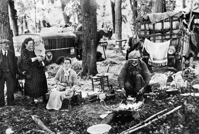 Camping in a forest near Paris, these refugees appear somewhat bewildered by the sudden series of events that has made them homeless. The swiftness of the German advance through France and the Low Countries in the spring of 1940 took the world by surprise and resulted in the mass dislocation of many citizens of France, Belgium, the Netherlands, and Luxembourg.