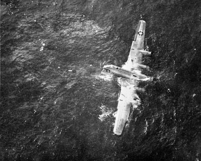 Not all the raiders escaped scot-free. Here half a B-29 that ditched in the sea remains afloat with a surviving crew member clinging to the No. 1 engine at top. 