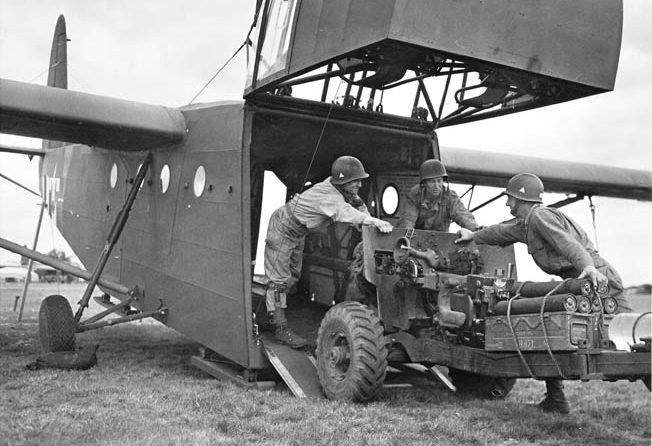 A 57mm antitank gun is loaded into a Waco glider on September 16, 1944, in preparation for the drop into Holland. The nose of the glider was hinged to allow for large pieces of equipment to be loaded and off-loaded. 