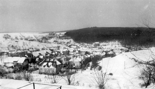 The snow-covered town of Ludweiler, Germany, appears tranquil in the midst of war. This photo was taken from the vantage point of a church overlooking the town on January 8, 1945, from the sector that was occupied by the U.S. 106th Cavalry. German troops defended the wooded area visible at upper right. LEFT: Soldiers of the Seventh Army man a .50-caliber machine gun during the days leading up to Operation Nordwind, the German offensive in southern France. As General George S. Patton, Jr.’s Third Army advanced northward during the Battle of the Bulge, the 106th Cavalry was charged with occupying an area Patton’s command had vacated.