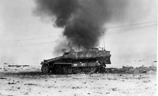 A German half-track burns after being hit. Bromberg’s tank crew knocked out a half-track that drove into the 2nd Armored Division’s line. Bromberg later ventured over to the destroyed vehicle for a closer look.