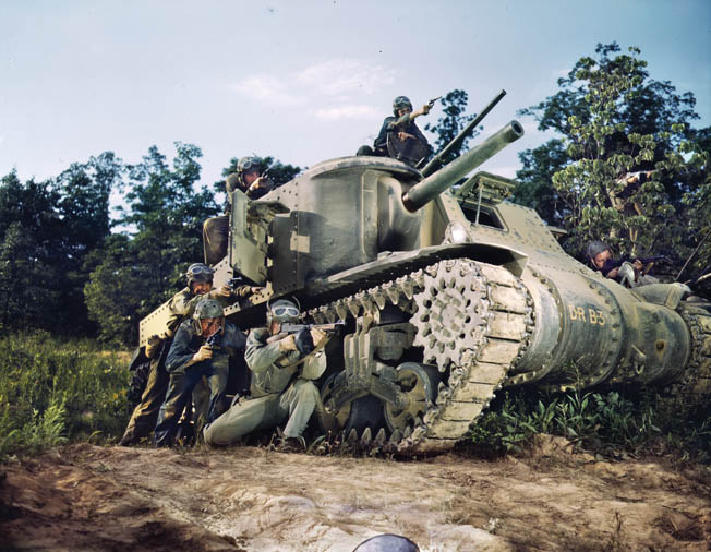 The crew of an M3 tank pose showily for a publicity photo during training exercises in 1942. General Alvan C. Gillem was among the first officers to command an American armored division.
