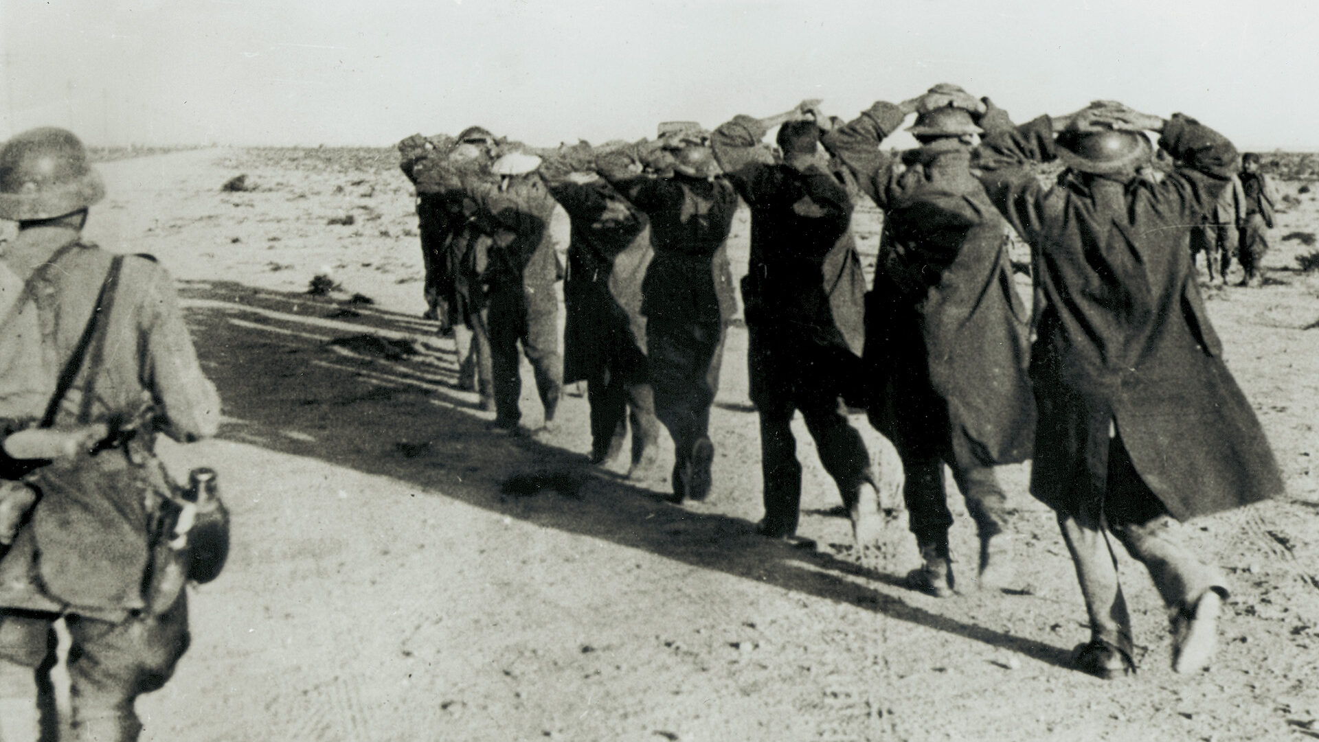 British prisoners march off under German guard after the capture of Tobruk. Rommel was aided in this astonishing coup of June 1942 by knowledge of British plans intercepted from messages by the U.S. Military Attaché in Cairo.