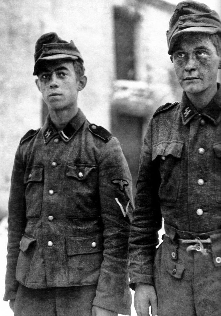 The Nazis impressed old men and boys to fight in the last days of the Third Reich. These two teenagers in German uniform were lucky to be alive when the fighting was over.