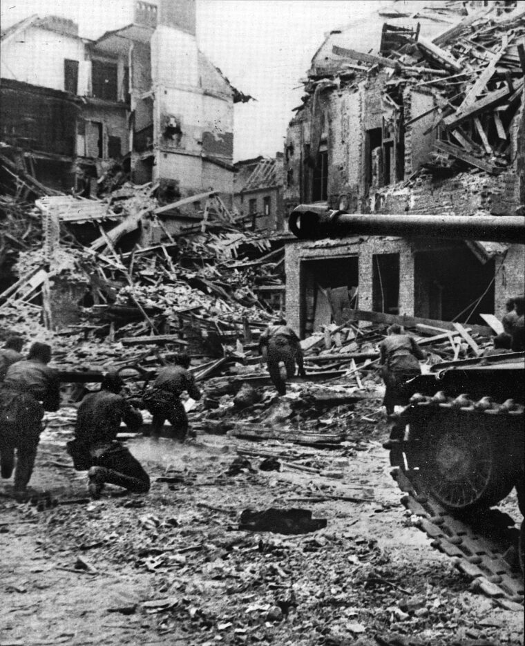 Red Army soldiers work their way through the rubble of a destroyed building in Berlin. Wary of snipers, the Soviet troops were compelled to clear streets, buildings and houses of stubborn German defenders.