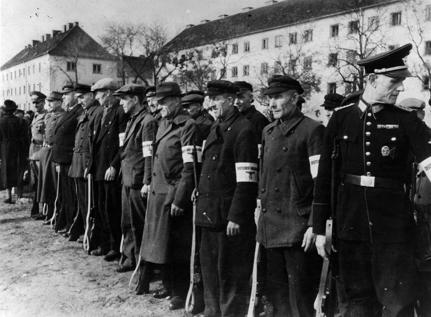 These old men of the Nazi Volksstürm assemble with rifles, soon to be committed to the defense of Berlin. The German defenders were decimated in the fight for the Nazi capital city.