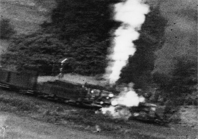 Riddled with .50-caliber bullets, a locomotive spews steam, smoke, and flames following a pass by an Allied fighter. German troop and supply trains were especially attractive targets for Allied tactical fighter groups flying low sweeps over the French countryside.