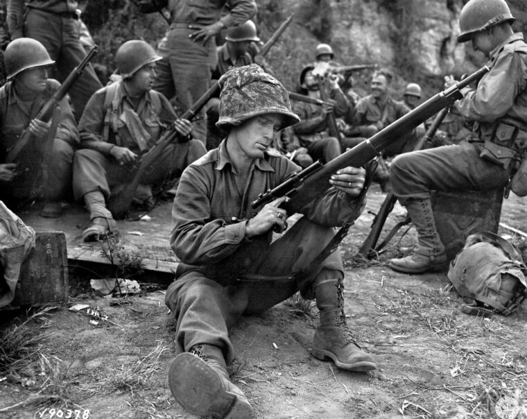 During a pause in the action near the town of Valletri, Italy, on May 29, 1944, Pfc. Edward J. Foley of the 143rd Infantry Regiment, 36th Division, cleans his Springfield M1903A4 sniper rifle. The remarkable service life of the M1903 rifle extended through the Vietnam era and beyond.