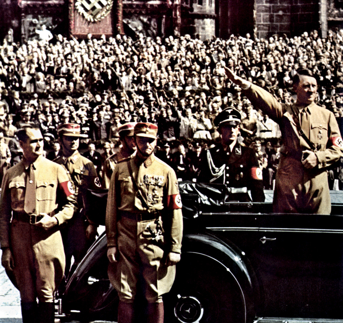 Hess, who served on Hitler’s cabinet and oversaw several departments, stands at far left beside Adolf Hitler’s Mercedes-Benz during the 1938 Nuremburg rally.