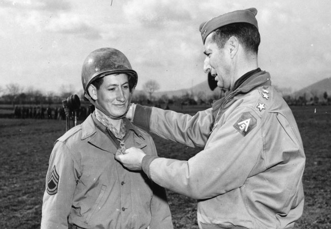 “Commando” Charles E. Kelly receives the Medal of Honor from Lieutenant General Mark Clark, commander of the U.S. Fifth Army in Italy.