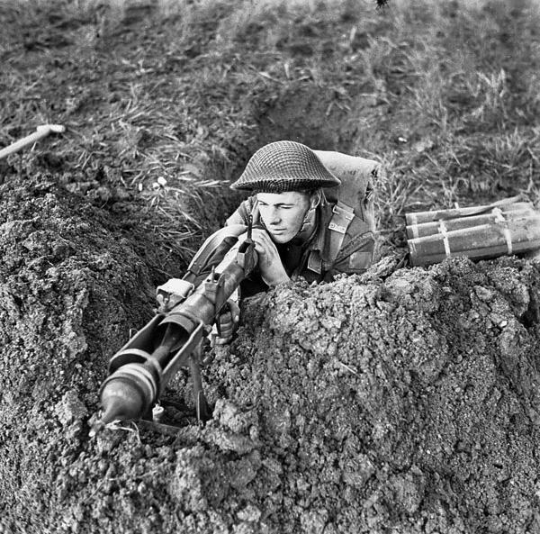 A Canadian infantryman aims a Projector Infantry Anti-Tank weapon from a concealed position in Ortona. The PIATs were effective against the workhorse German Panzer IVs. 