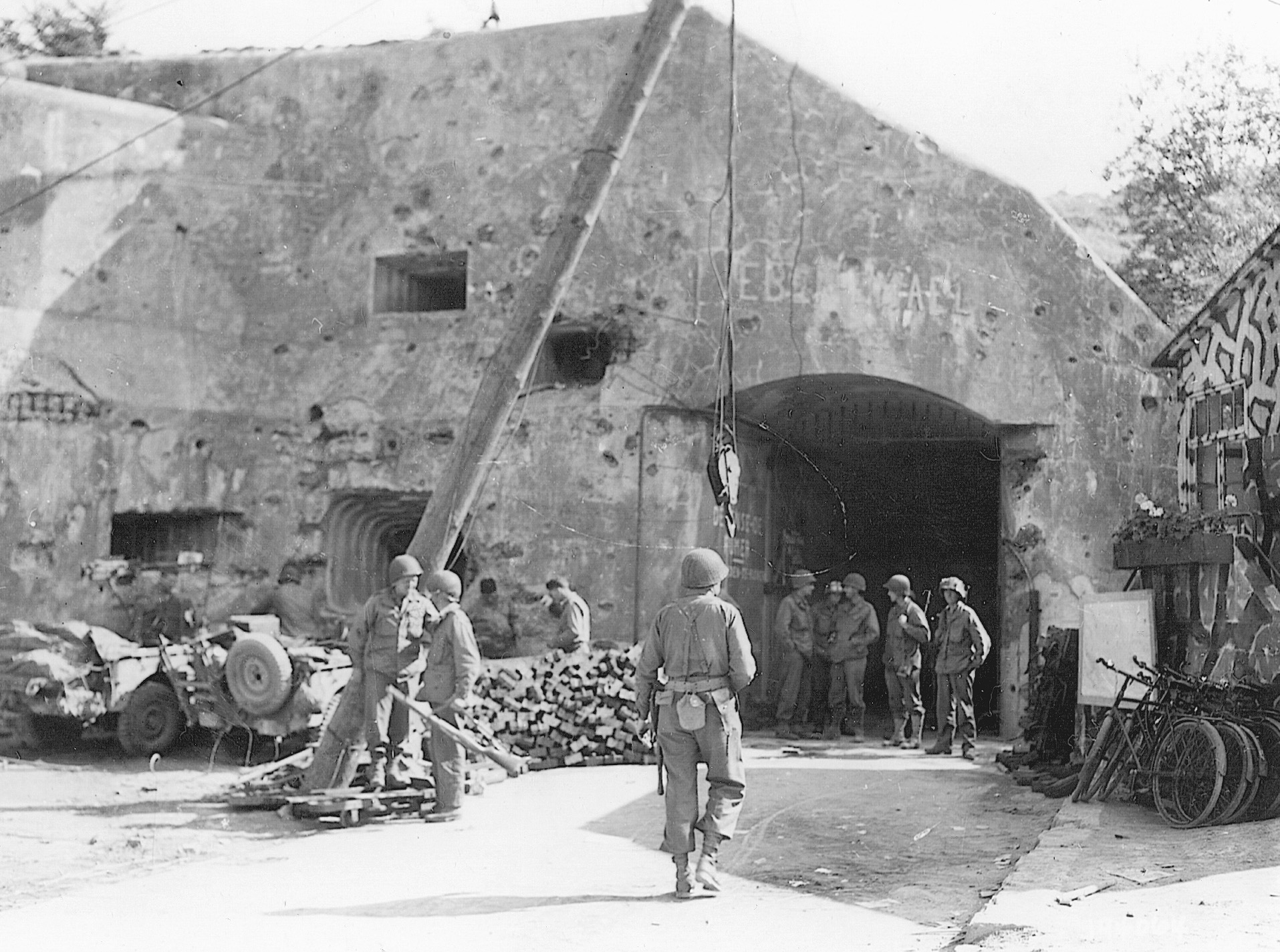 American soldiers mill around the entrance to Eben Emael in 1945. Damage from shell fire is apparent in both photos.