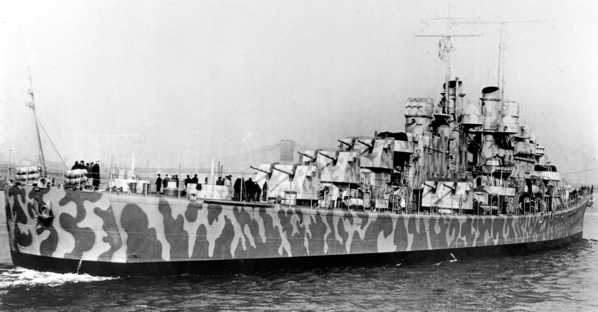 USSJuneau, painted with camouflage, in the safety of New York harbor.