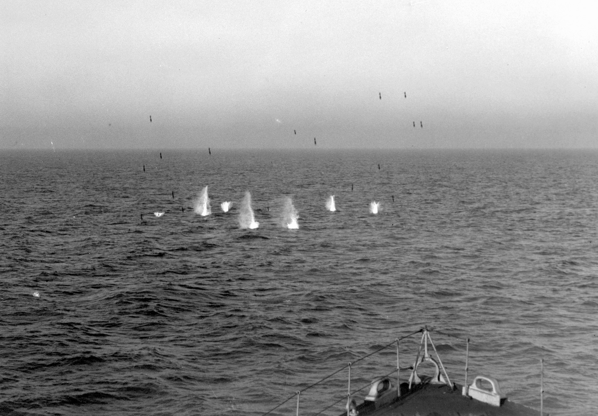  A full pattern of 24 Hedgehog bomblets, some still airborne, seeks an enemy submarine in the Atlantic.