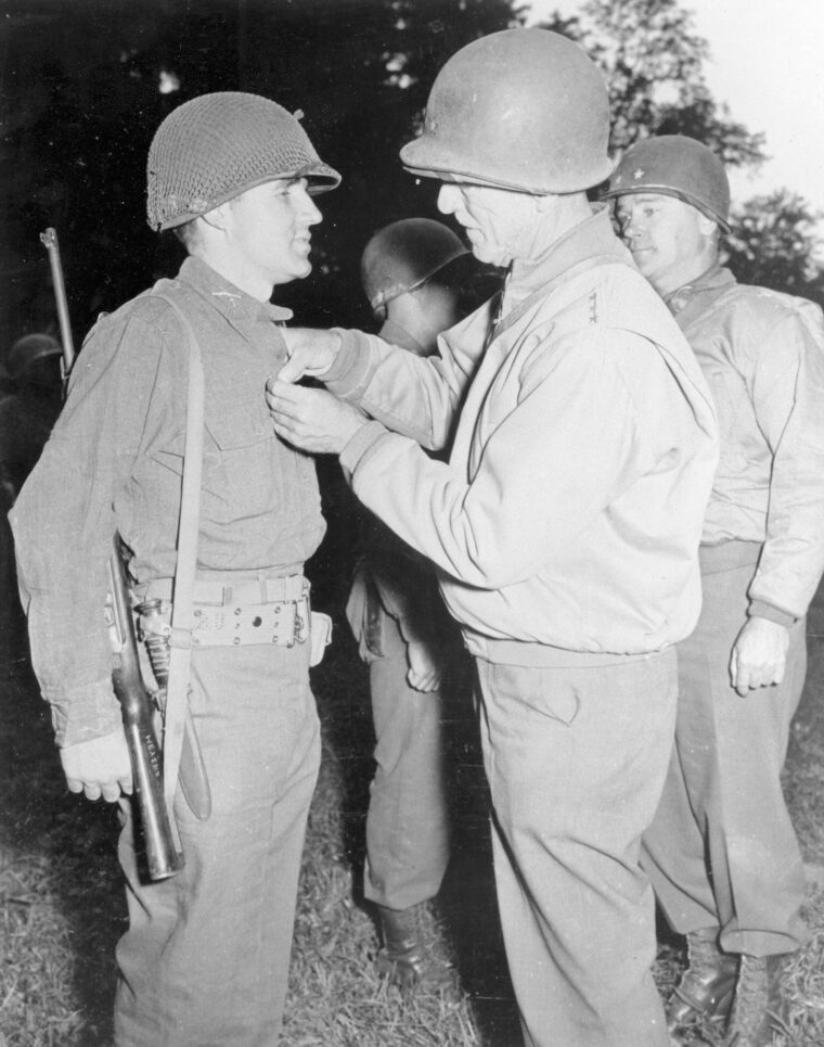 General William H. Sampson, commander of the U.S. Ninth Army, presents Mabry with the Distinguished Service Cross for his exploits on D-Day.