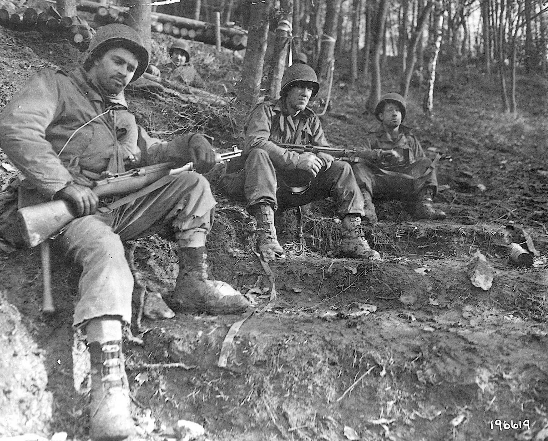 During the lull in the fighting on November 18, 1944, the faces of these Americans reflect the strain of combat in the Huertgen Forest.