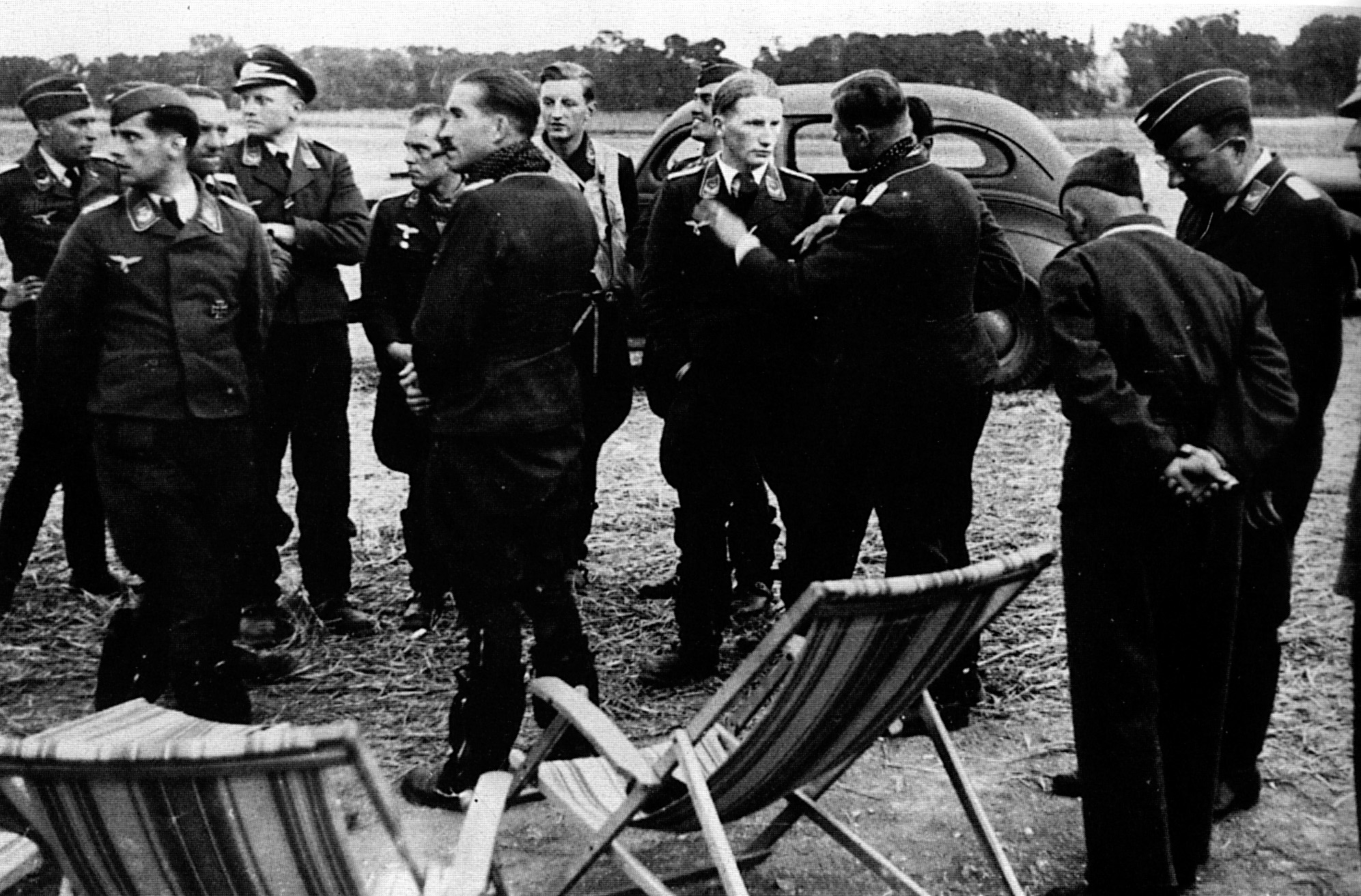 Galland is here shown with scarf at an airfield in France during the Battle of Britain. Surrounding him are officers of his Third Gruppe.  