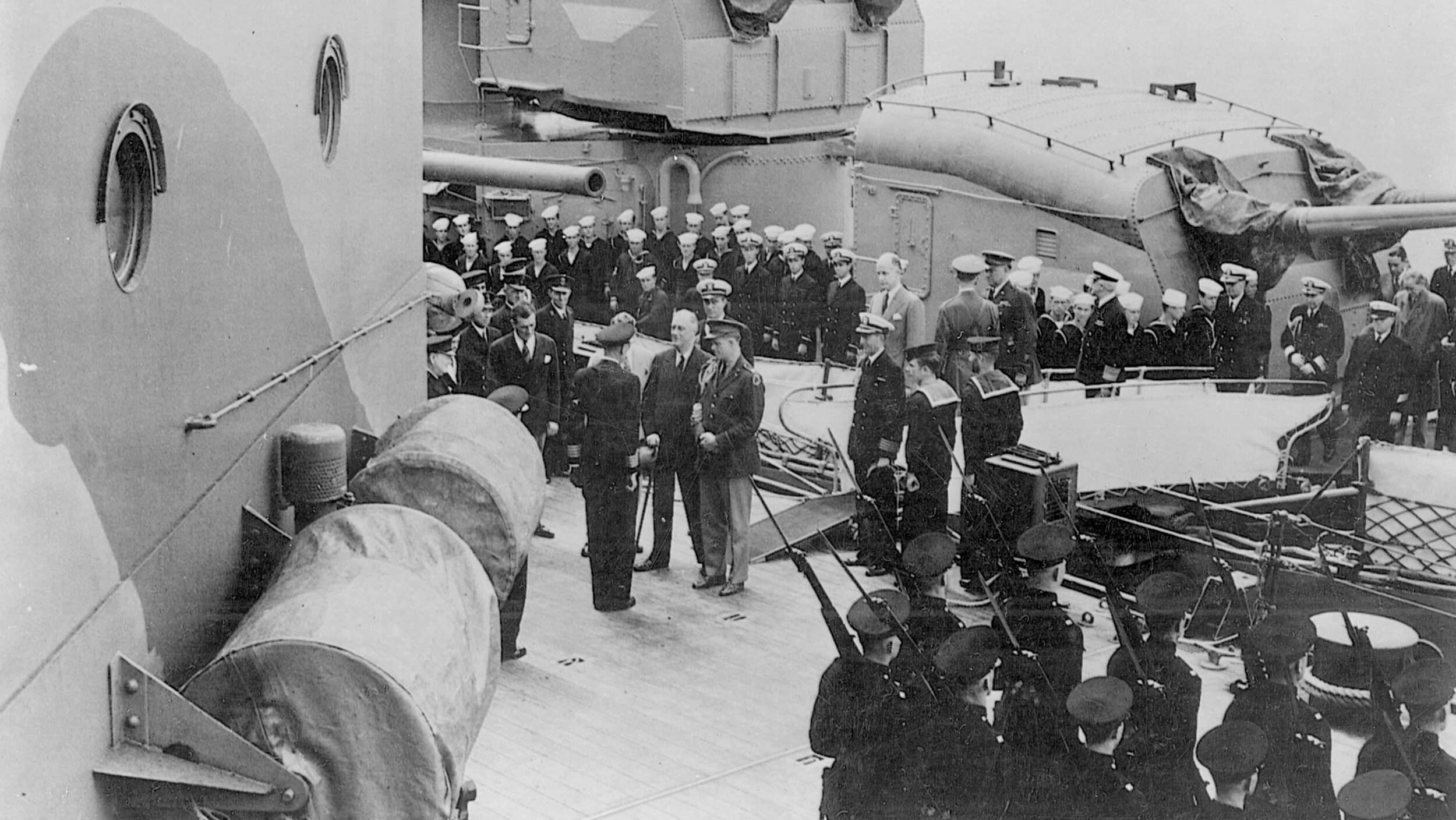 President Franklin D. Roosevelt boards the battleship HMS Prince of Wales to attend his first meeting with Prime Minister Winston Churchill.