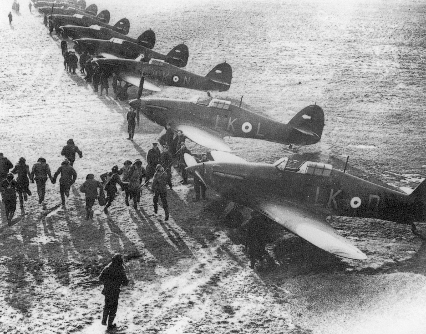 RAF pilots scramble to reach their Hurricane fighters.