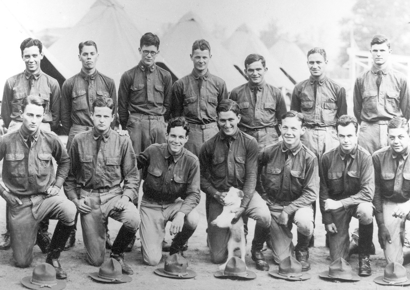 A group of cadets at Fort Myer includes Pulliam (fourth from left) and Shell (first on right) in the back row, and Roberts in the front row holding the dog.