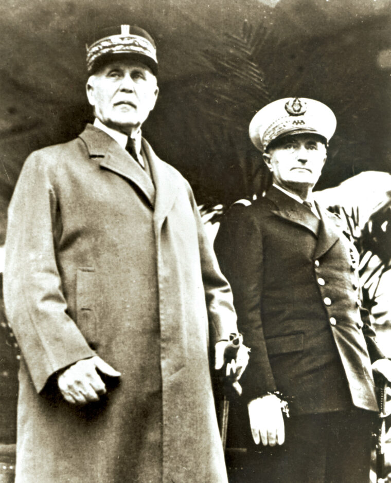 Admiral Darlan (right) stands with Vichy France’s Prime Minister Philippe Pétain during a ceremony in September 1941.