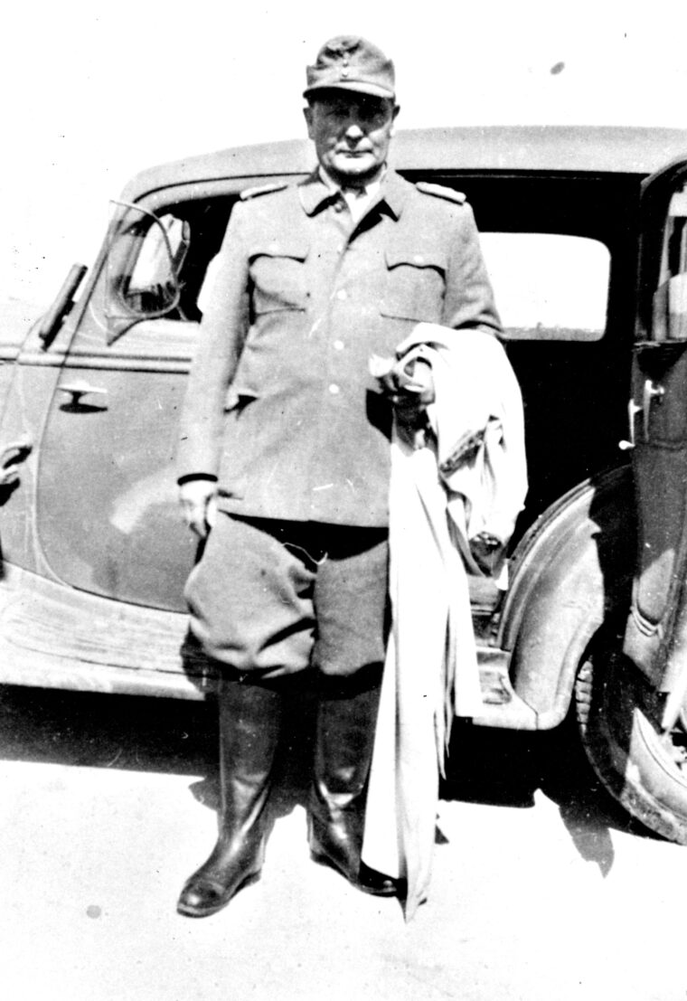 A prisoner of the U.S. Army, Göring has been stripped of his rank, medals, and marshal’s baton. Here, he stands in front of an American staff car. 