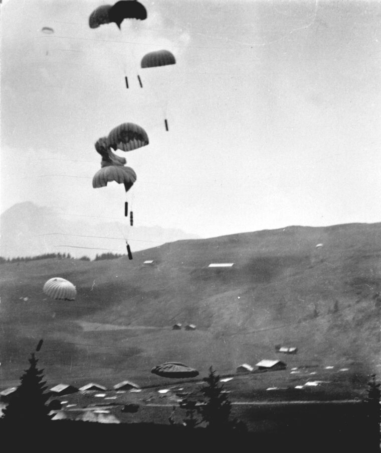 Badly needed supplies parachute earthward to replenish weapons, ammunition, and medical stores for the Resistance in occupied France. 