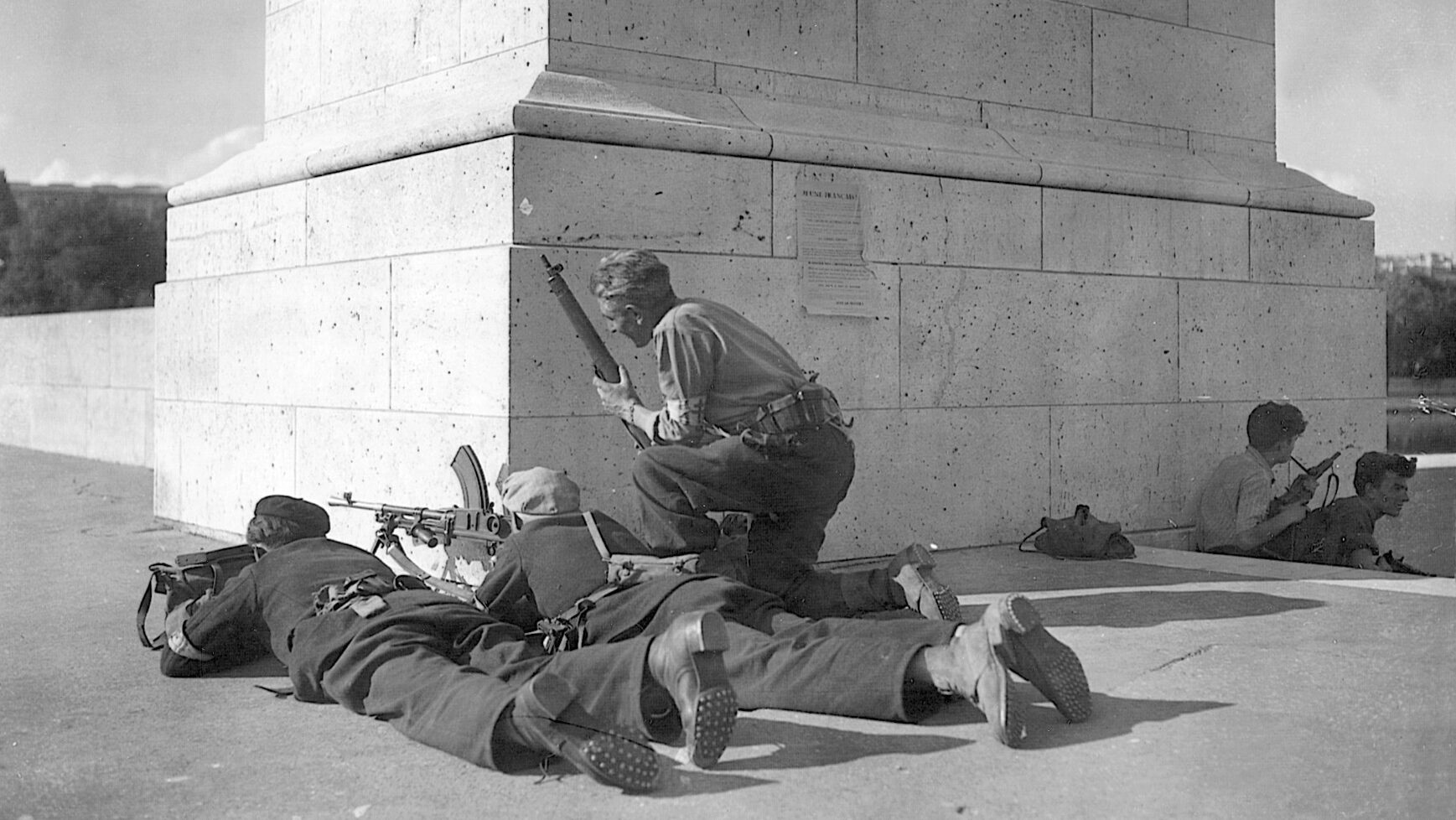 A squad of French Resistance fighters, some sighting automatic weapons, anticipates action against the Nazis, August 1944.