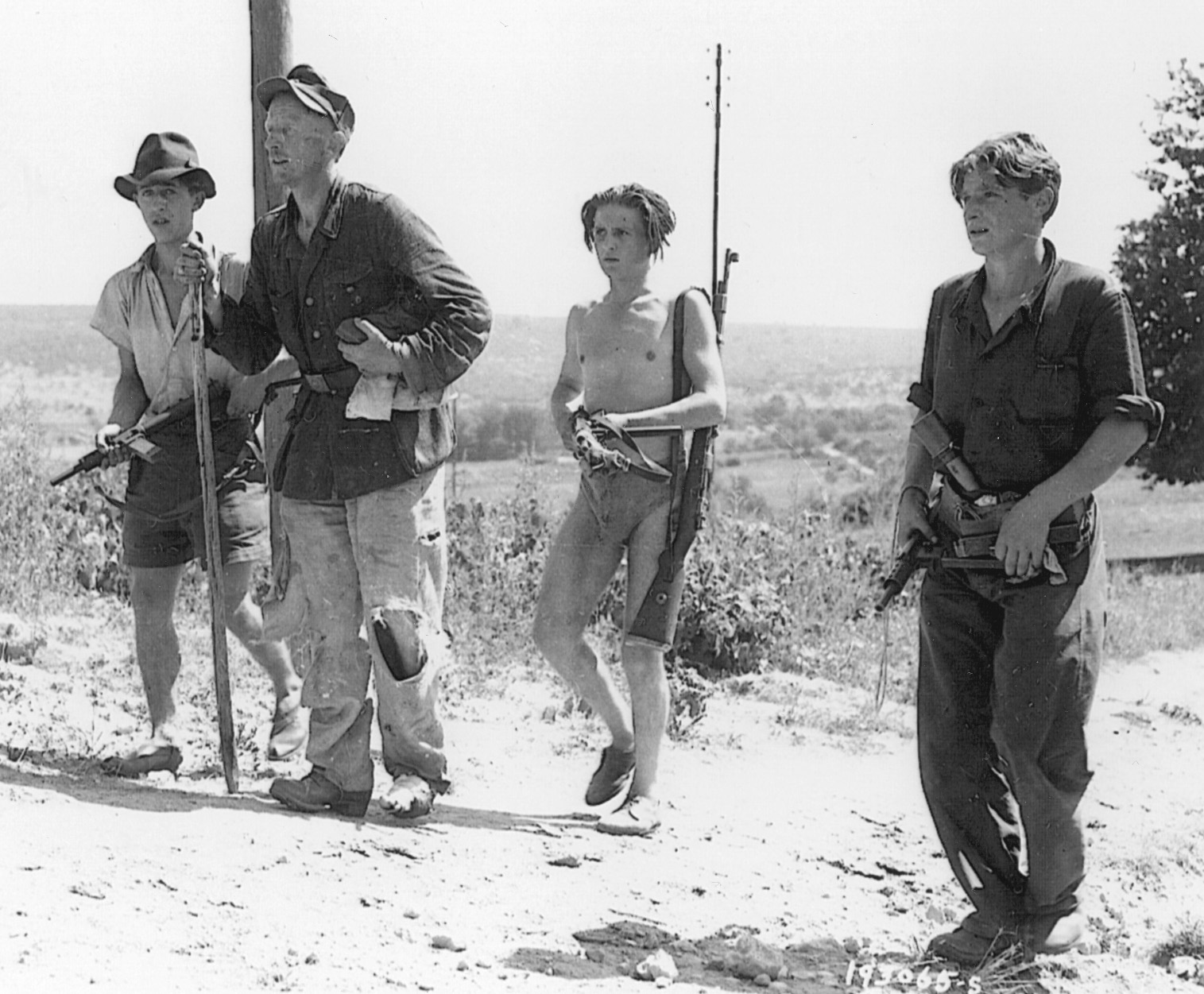 French Resistance fighters march a German prisoner into captivity in southern France, August 1944.