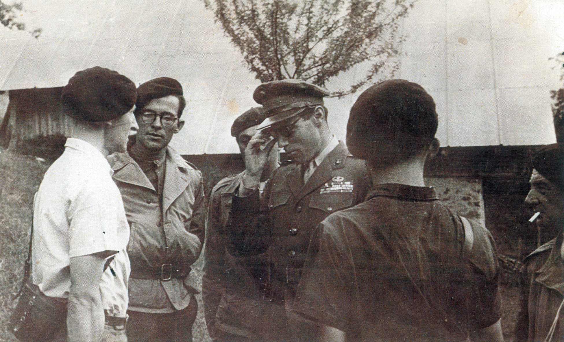 Major Peter Ortiz (center with sunglasses) discusses Operation Union with a group of French Resistance fighters. 