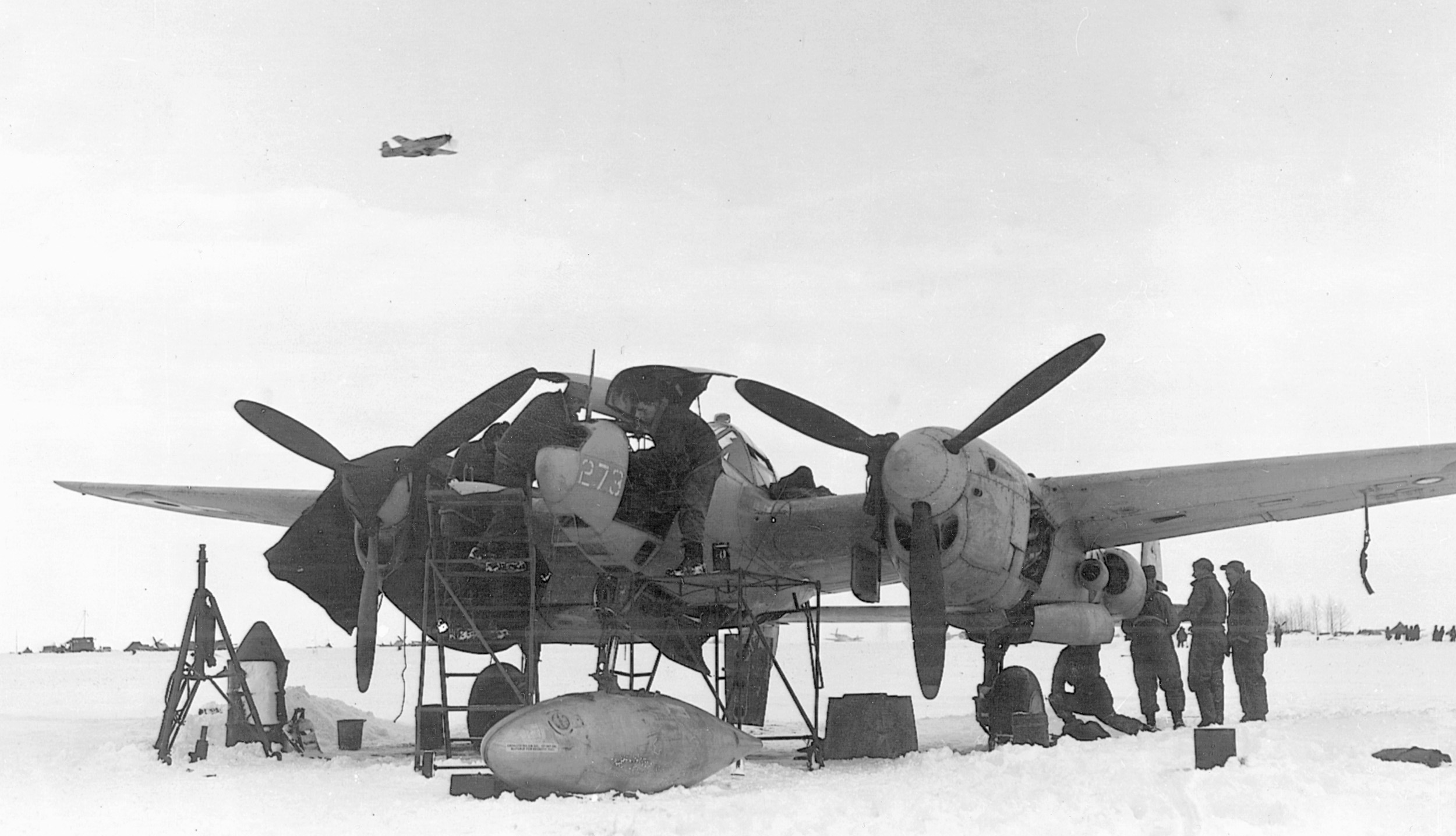 A P-38 is serviced on a snowy field at Charleroi, Belgium.