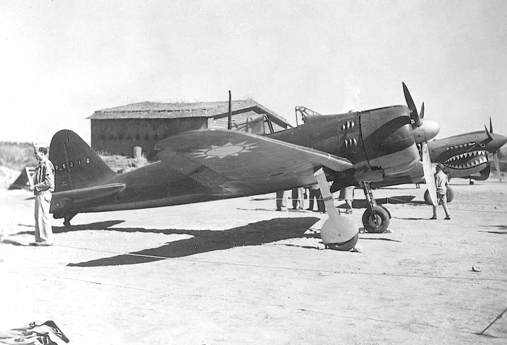 A Zero fighter captured by the Allies and bearing Chinese markings sits beside P-40 Tomahawk fighters of General Claire Chennault’s Flying Tigers.