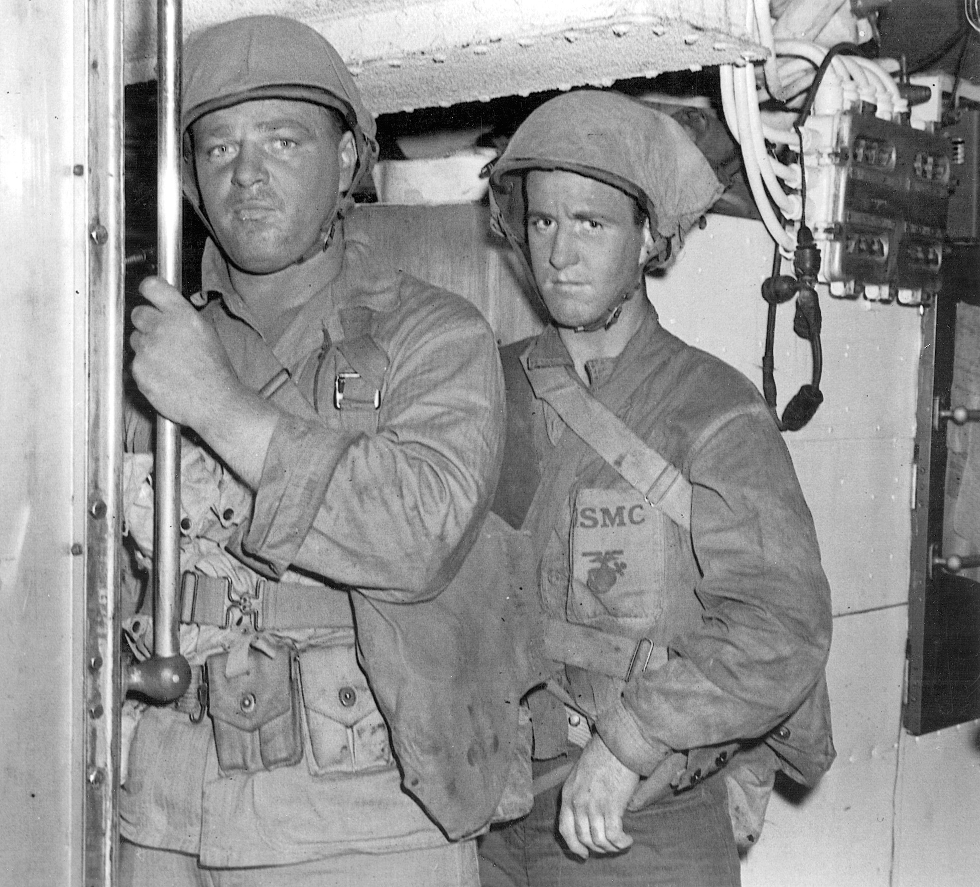 Laden with equipment, a pair of Carlson’s Raiders heads topside aboard the submarine USS Nautilus, their destination Makin Island.
