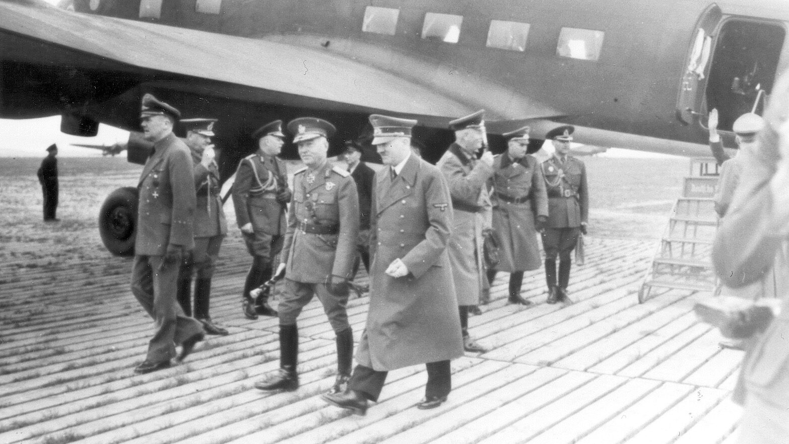 At Rangsdorf Airfield near Hitler’s headquarters at Rastenburg, East Prussia, the Führer and Romanian Marshal Ion Antonescu walk away from a Focke Wulf Condor piloted by Baur.
