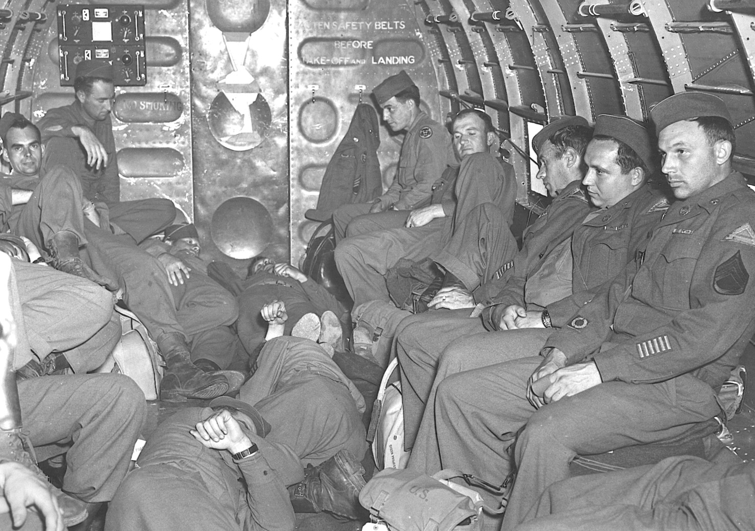 U.S. military personnel endure a long flight home aboard a Douglas C-47 in June 1945. 