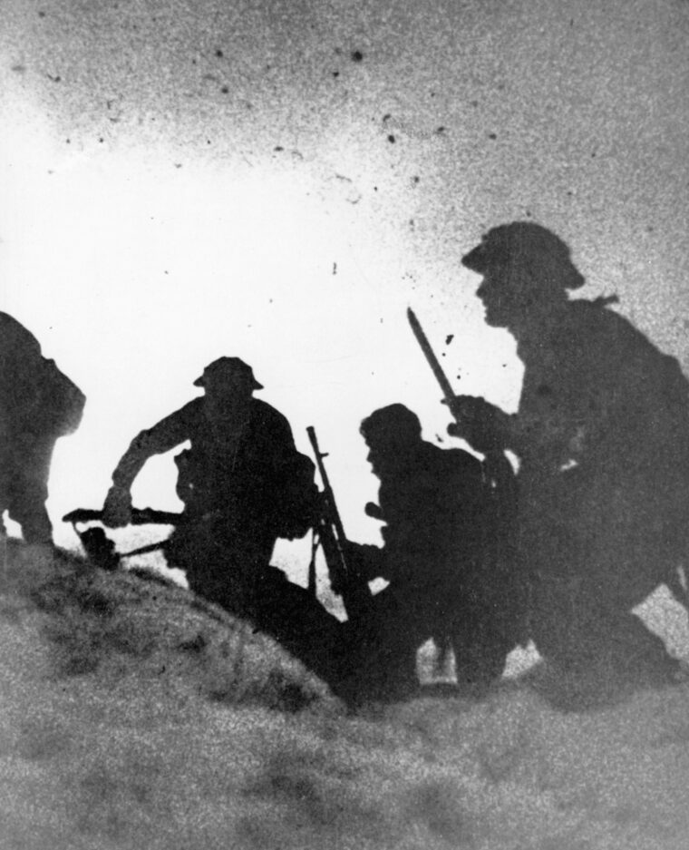 Commandos move up the beach at Vaagso through a smoke screen laid down by RAF bombers.