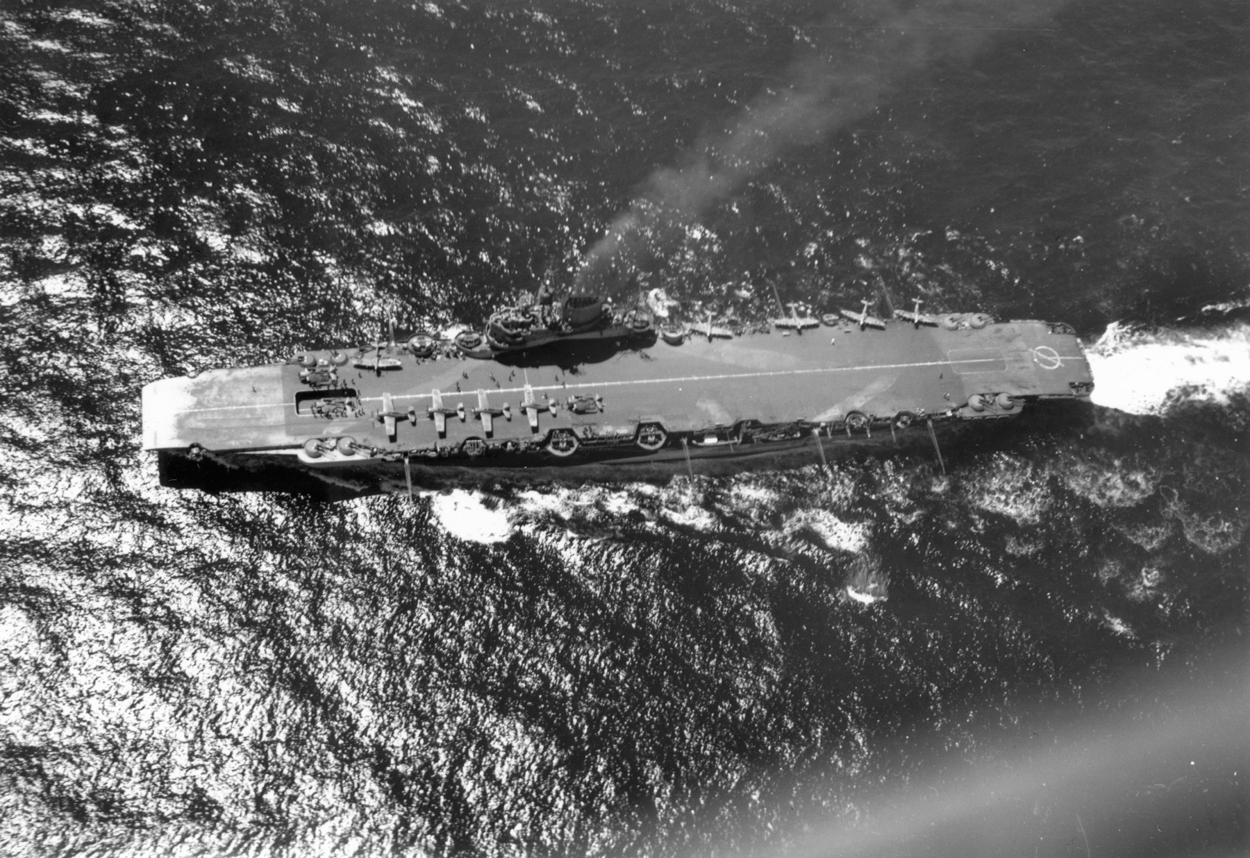HMS Formidable steams ahead in the Atlantic. The armored carrier also saw action in the Mediterranean and the Pacific, sustaining damage inflicted by both German and Japanese forces.