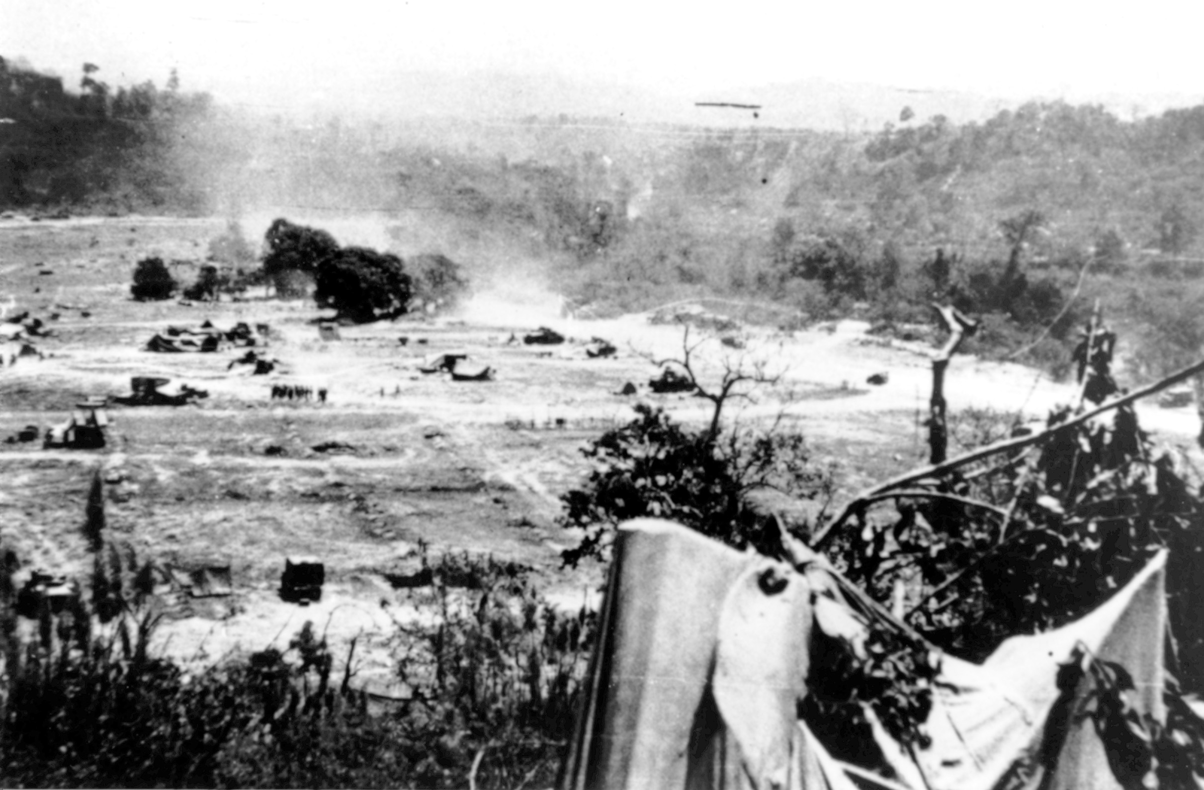 As seen from Ammunition Hill, the Admin Box comes under fire from Japanese artillery.