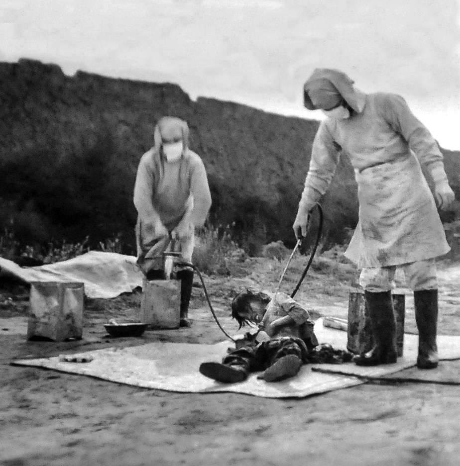 A pair of Japanese members of Unit 731 conduct an experiment on a helpless prisoner. 