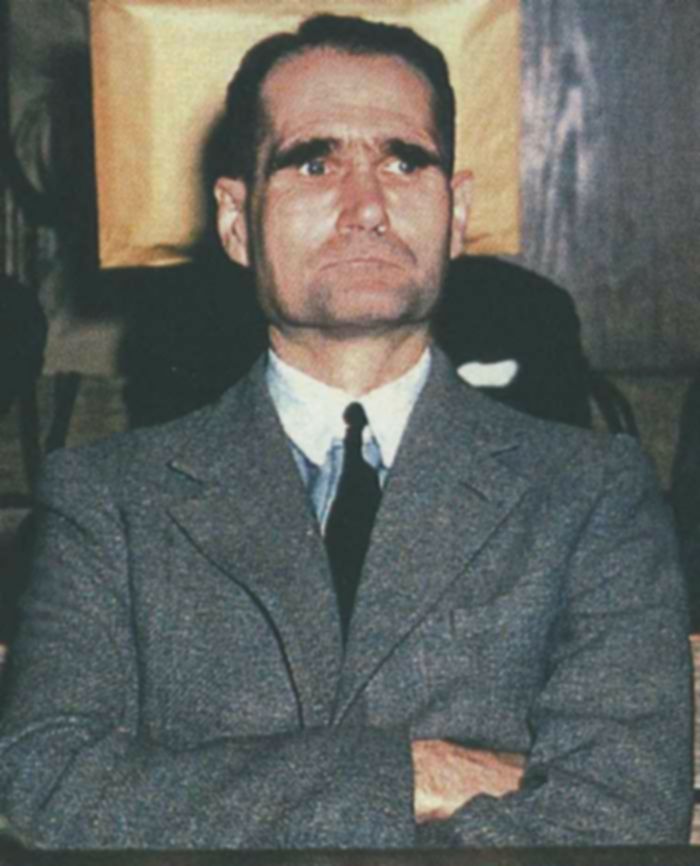 A gaunt Rudolf Hess sits in the courtroom at Nuremberg in 1946, surrounded by former Nazis on trial for war crimes.