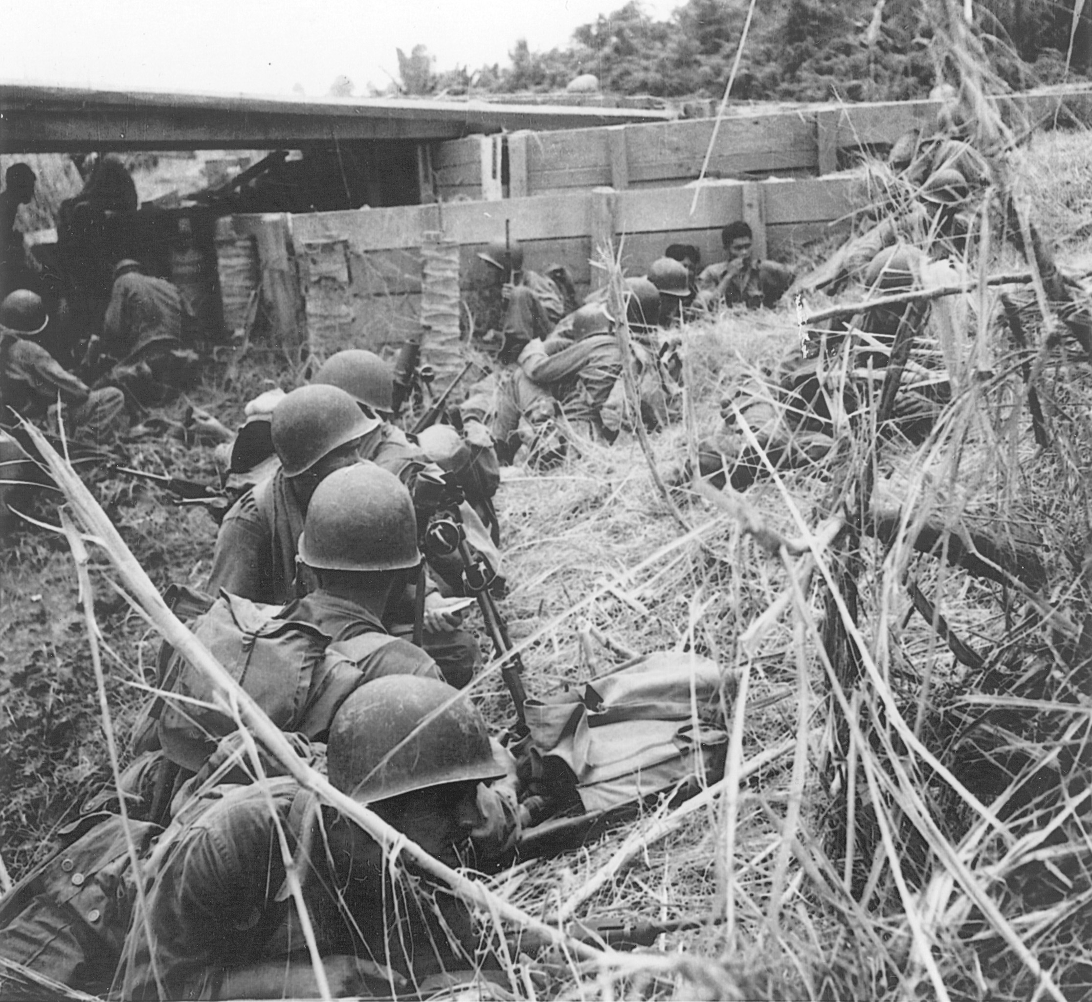 As artillery shells begin to fall, 24th Division soldiers take cover along the National Highway, a road leading into Davao, Philippines.