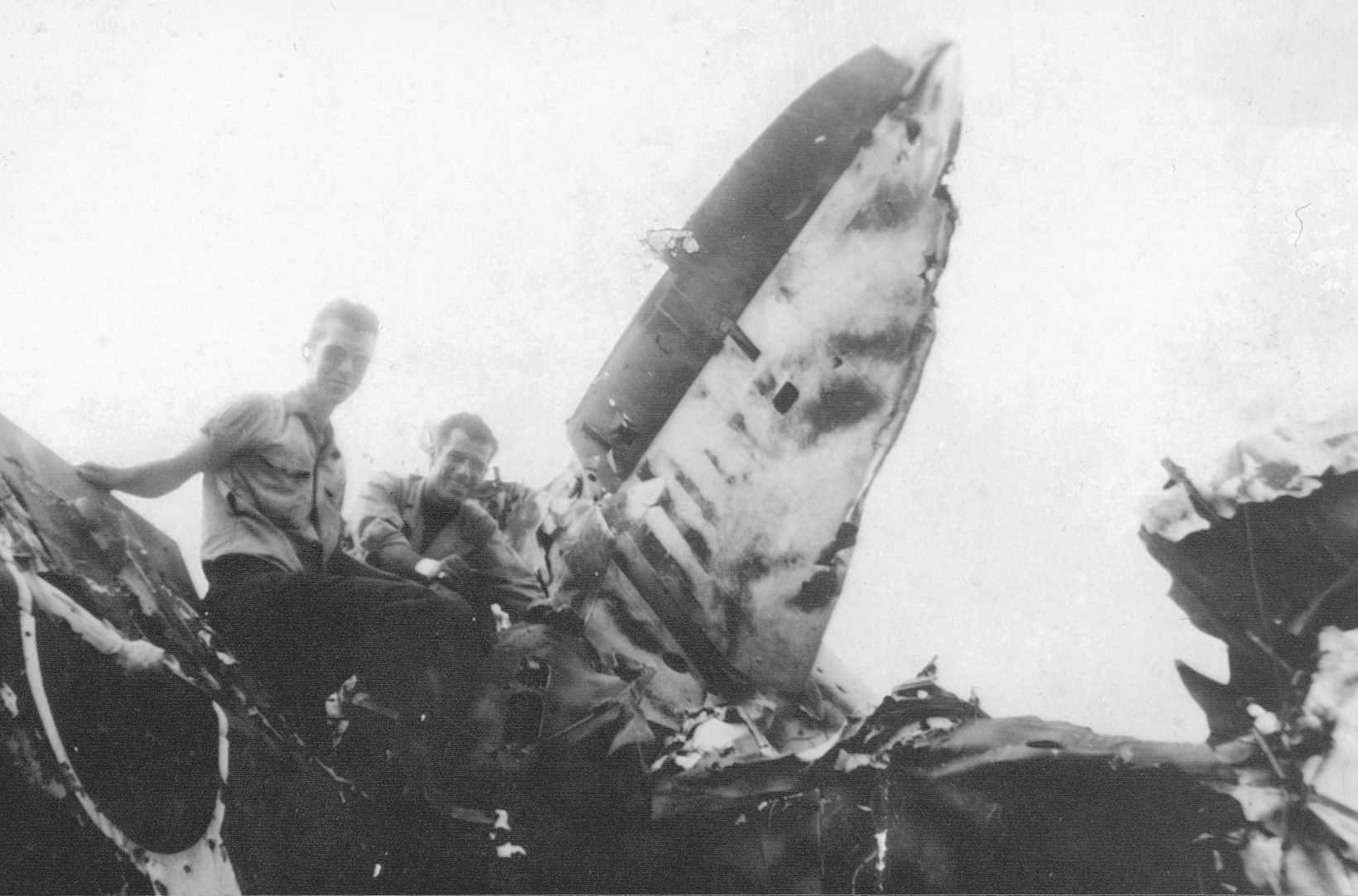 Red Mantini (right) and a comrade pose atop a wrecked Japanese aircraft in their search for souvenirs.