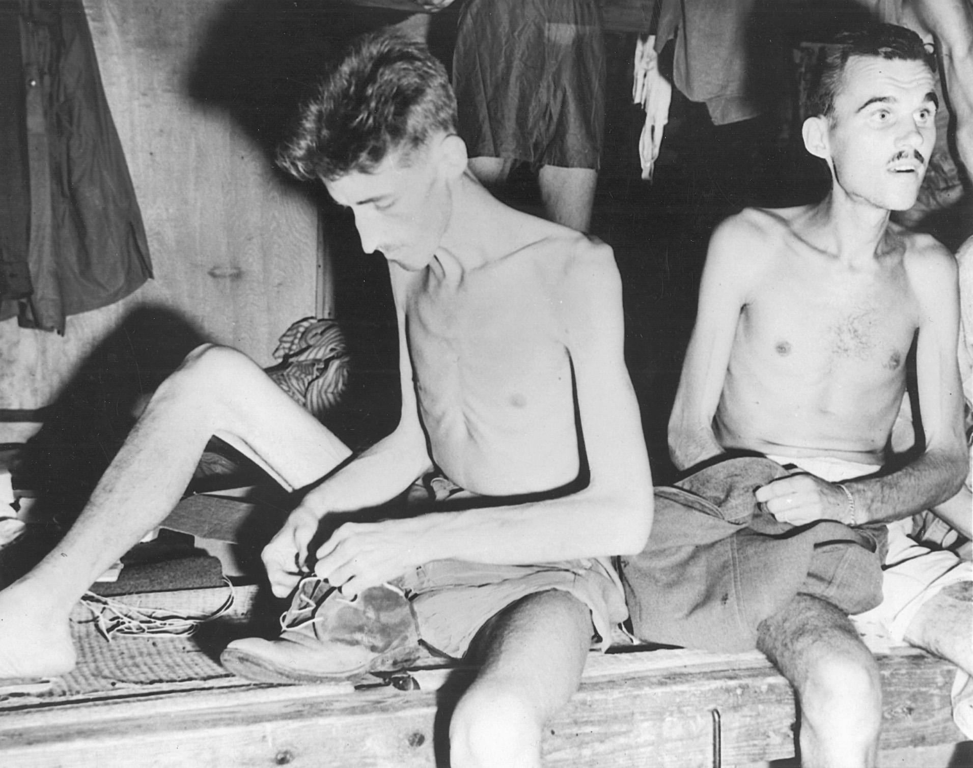 After receiving news of the Japanese surrender, emaciated Allied prisoners prepare to vacate their camp in Yokohama, Japan.