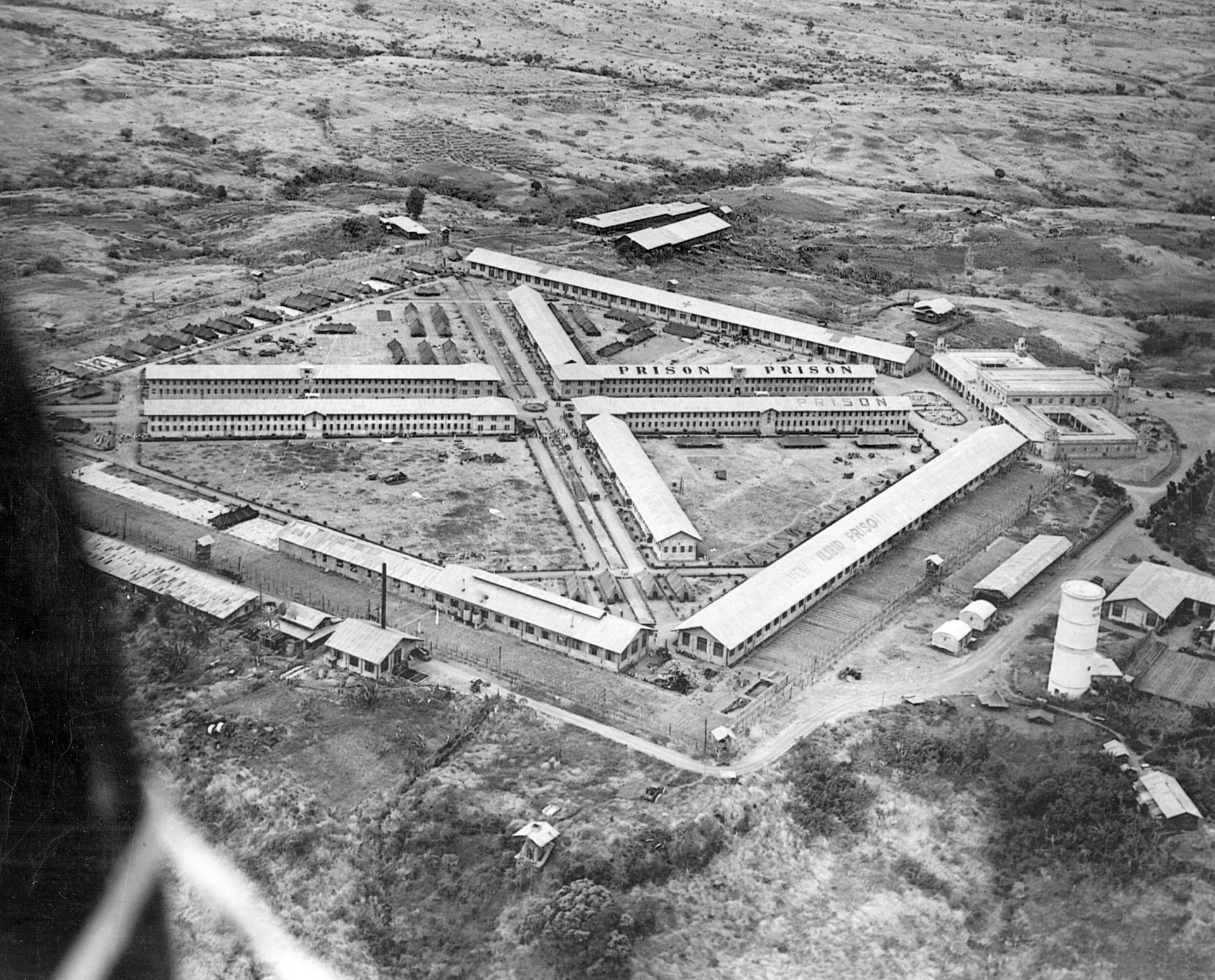 The prison camp at Los Baños in the Philippines is clearly marked to prevent a strike by prowling American aircraft.